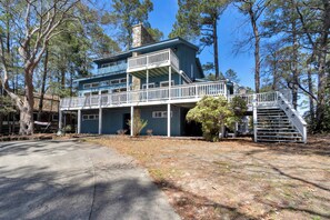 A two-story house with a balcony, a staircase, and a garage. - Spectacular Views, Close to everything Rehoboth + Pet Friendly! (Rehoboth Beach)