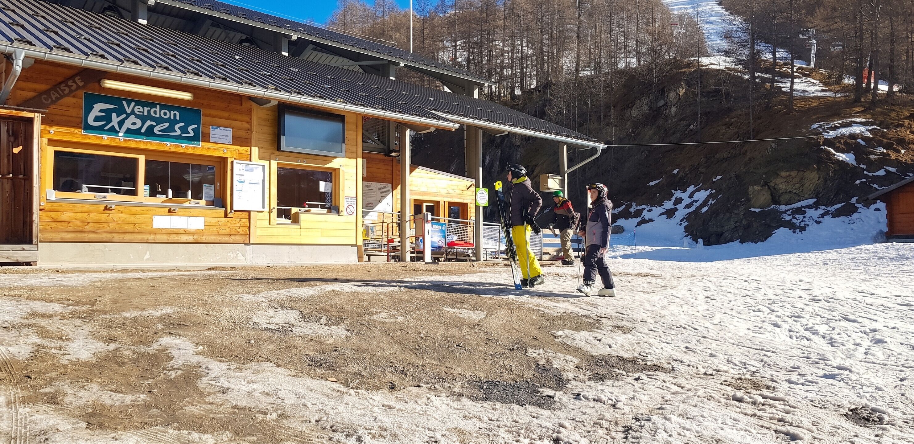 A wooden building with a sign for 'Veron Express' and a ski lift in the background.