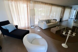 A modern living room with a sofa, armchair, and a coffee table. - Exquisite villa with heated pool near beach A3697 (Lège-Cap-Ferret)