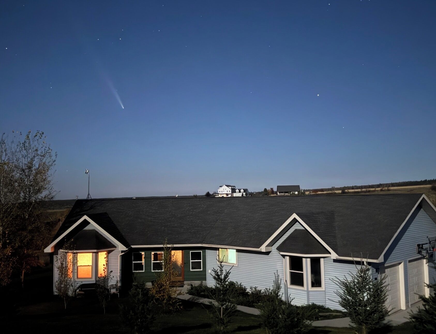 Zona residencial con casas, cielo despejado y una antena parabólica visible.