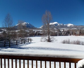Enjoy breathtaking views of snow-covered mountains from this serene outdoor space.