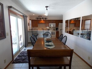 Enjoy meals with family and friends in this dining area, featuring a long table and six chairs.