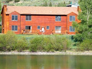 Situated near a serene body of water, this cabin offers a peaceful retreat with a spacious porch and deck.