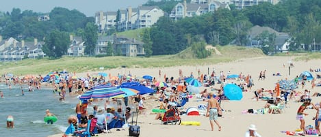 Guests can enjoy a lively beach scene with sandy shores and clear views.