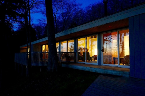 Exterior, water side of house. Every room faces the water with doors to deck.