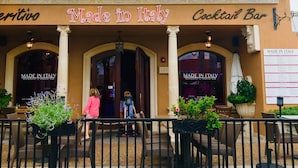 A restaurant with a sign reading "Made in Italy" and "Cocktail Bar". - BEAUTIFUL HOME WITH HEATED POOL!!! (Venice)