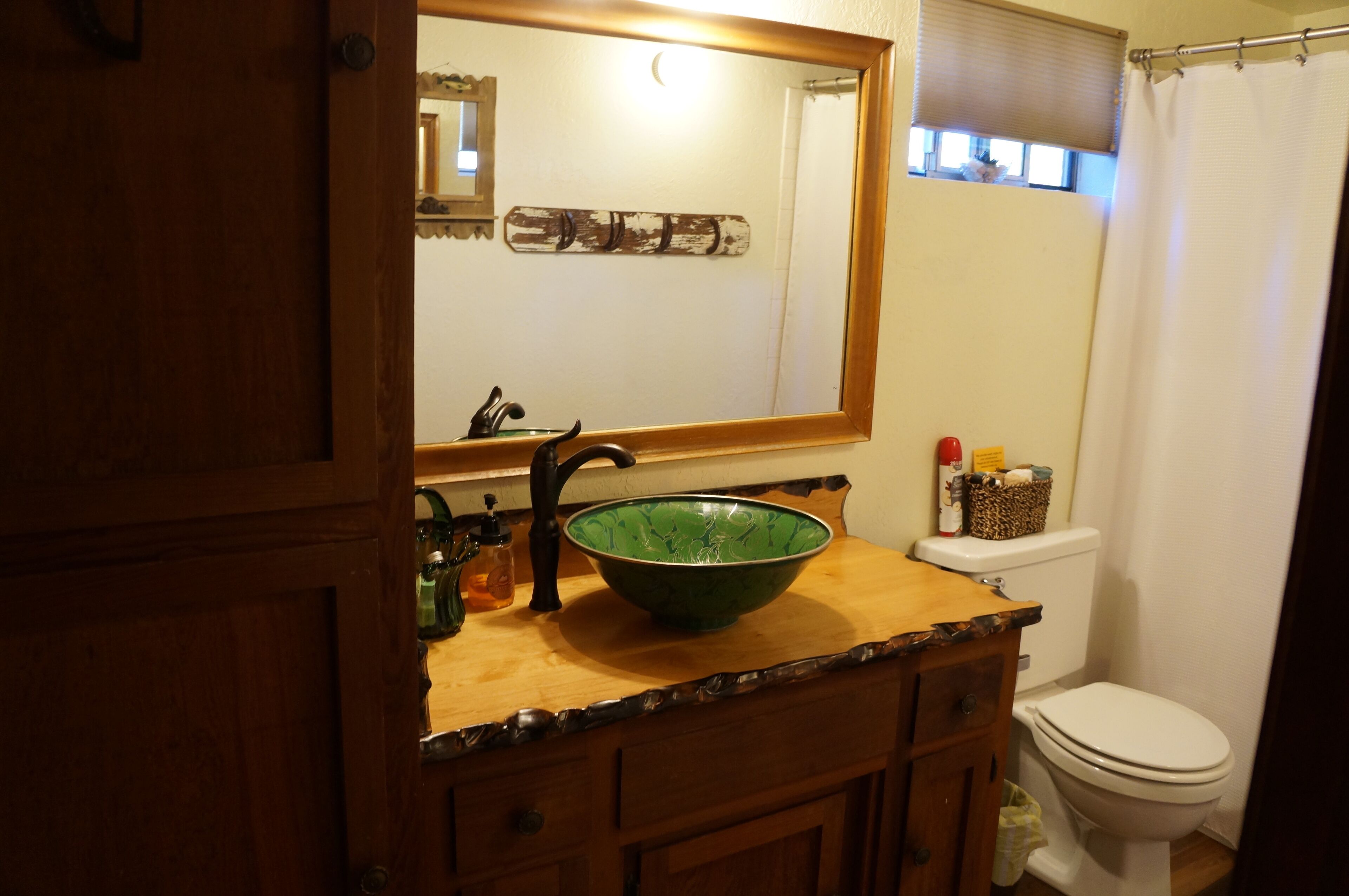 Downstairs bath with a custom counter top and bowl sink.