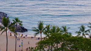 A beach with palm trees and people. - Beach Front Studio With Spectacular Ocean Views (Honolulu)