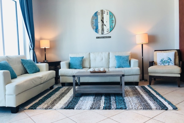 Living room with incredible views of the beach, pool, and hot tub