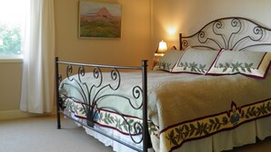 A bedroom with a bed, a ceiling fan, a window with curtains, and a painting on the wall. - Vineyard FarmStay, & Heated Pool from May-Oct. (Glen Ellen)