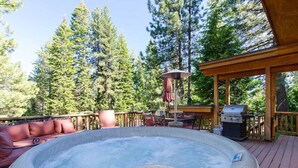 A hot tub on a wooden deck with a grill and outdoor furniture. - Fabulous Cabin Block away from<br>Private Beach (Tahoe City)