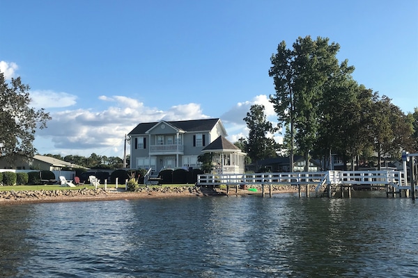 Water view of the home, yard and dock