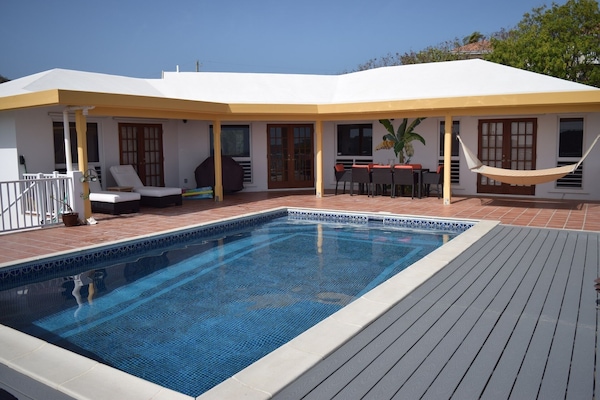 View of home's private exterior and pool.