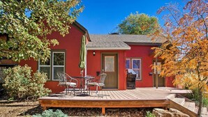 A red house with a wooden deck, a door, and a window. - Purple Juniper: Downtown witth Sunny Front Deck (Durango)