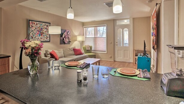 A kitchen with a granite countertop, a blender, and a vase of flowers. - Purple Juniper: Downtown witth Sunny Front Deck (Durango)