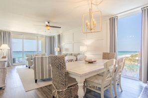 Relax in this stylish room with a dining table, sofa, and balcony offering a beach view.