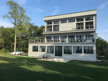 Lakeside with tons of windows, huge 2nd floor deck with couch, table, and grill.