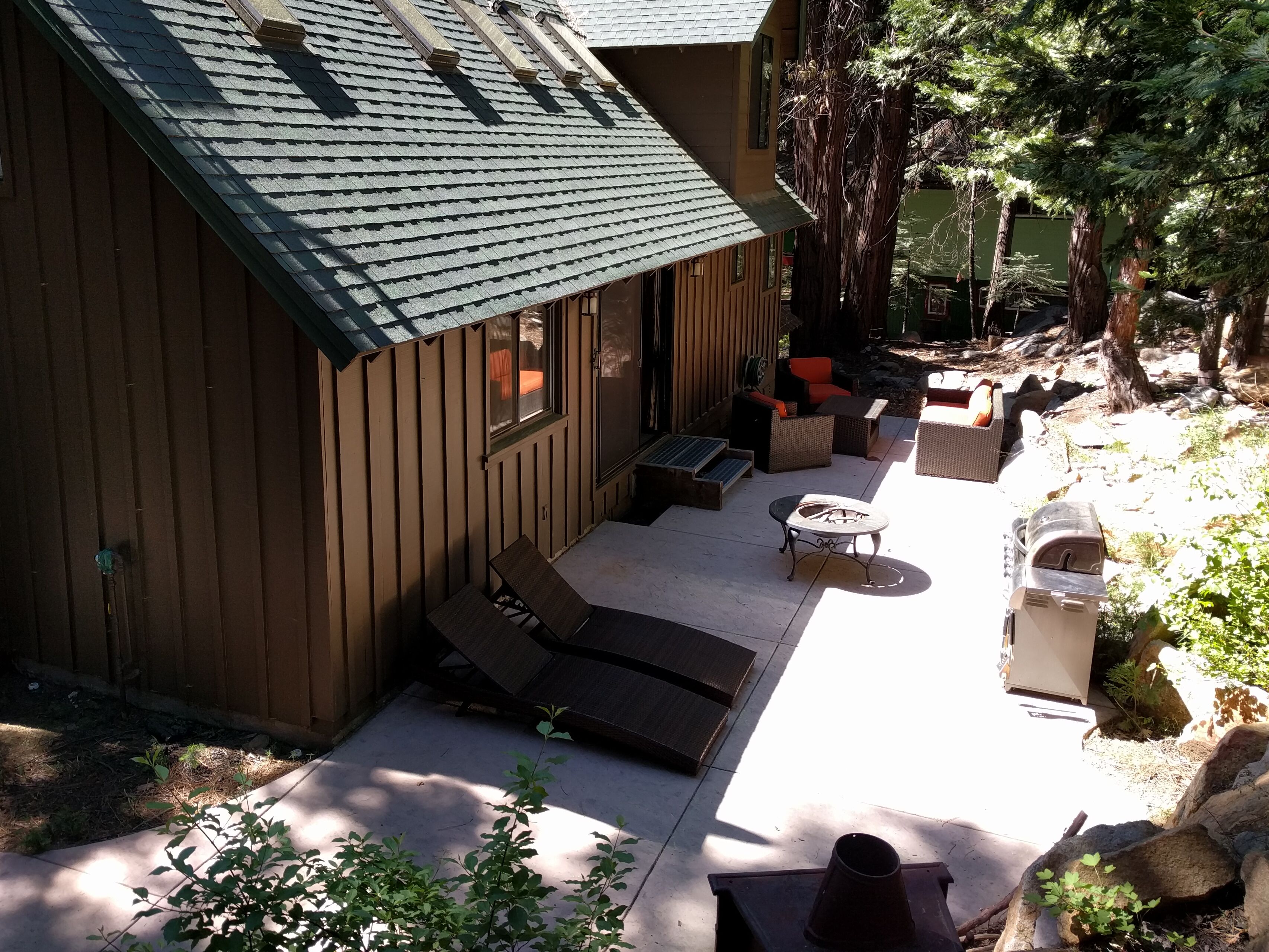 Back patio - grill, couch, chairs, table, and four loungers.