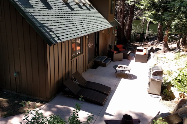 Back patio - grill, couch, chairs, table, and four loungers.