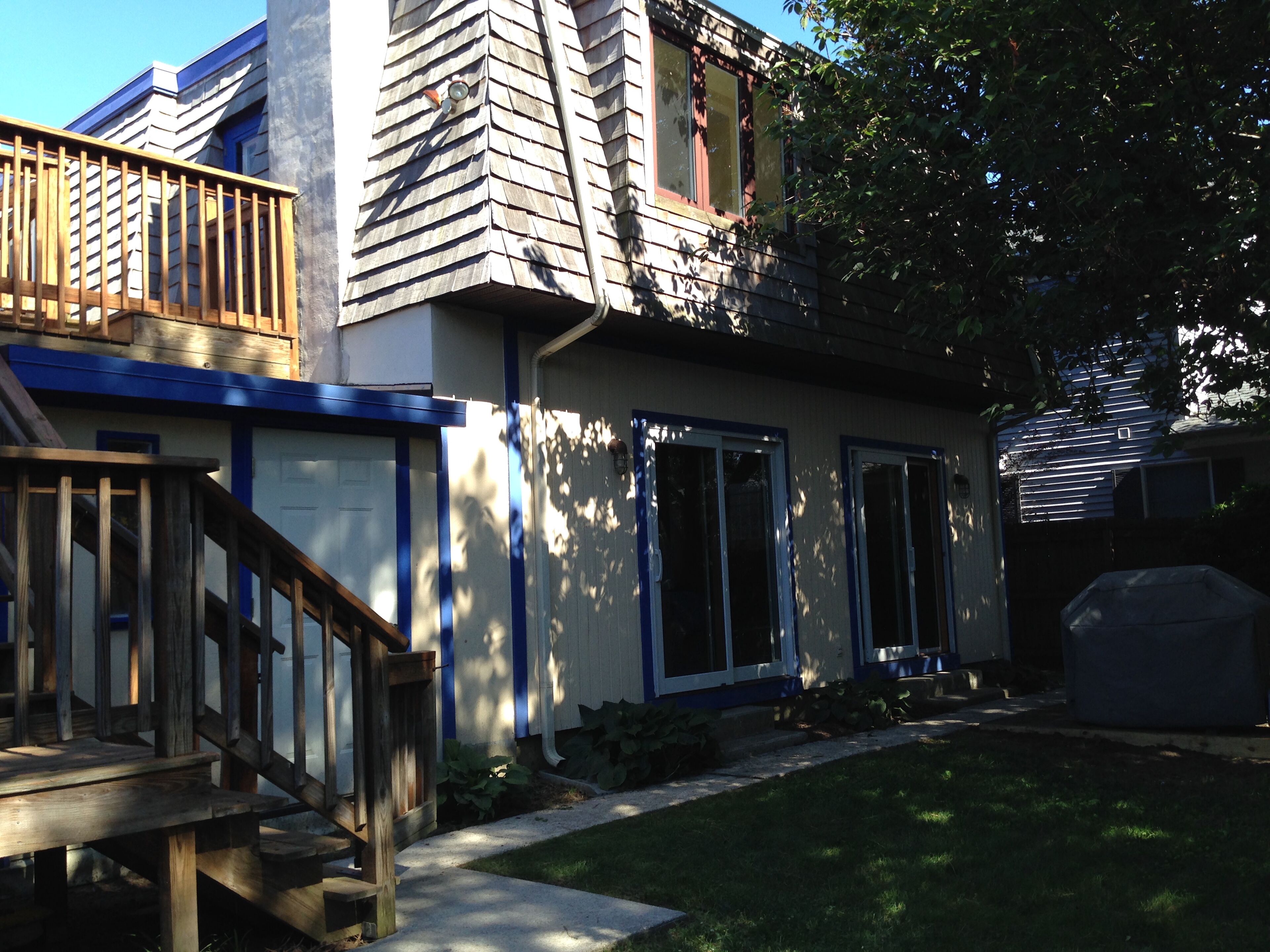 A residential house with a front porch, a staircase, and a garage.