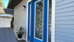 A house with a blue front door, a number '110' on the wall, and a welcome mat on the porch. - WALK EVERYWHERE!  SPACIOUS 4BR HOUSE, IN-TOWN REHOBOTH BEACH! PET-FREE. (Rehoboth Beach)