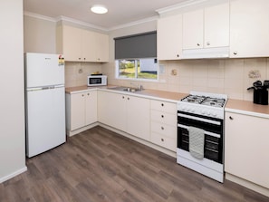 Standard 2 Bedroom Cabin | Private kitchen | Full-size fridge, microwave, oven, stovetop