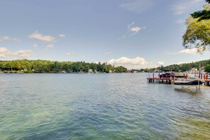 A lake with a dock and a boat named "JETSKI" on it. - Laconia Home w/ Beach - 1/2 Mi to Weirs Beach (Laconia)