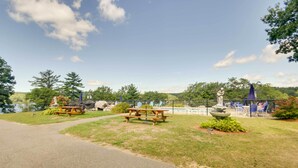 A park with picnic tables, a fountain, and a statue. - Laconia Home w/ Beach - 1/2 Mi to Weirs Beach (Laconia)