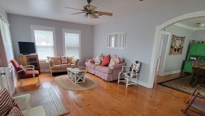 A spacious living room with hardwood flooring, a ceiling fan, and a green cabinet. - Beautiful hill country peace. (Blanco)