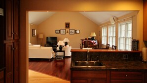 A spacious living area with a kitchen, a dining table, and a sofa.