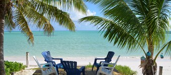 Step from your porch onto the soft white sand & crystal clear water.