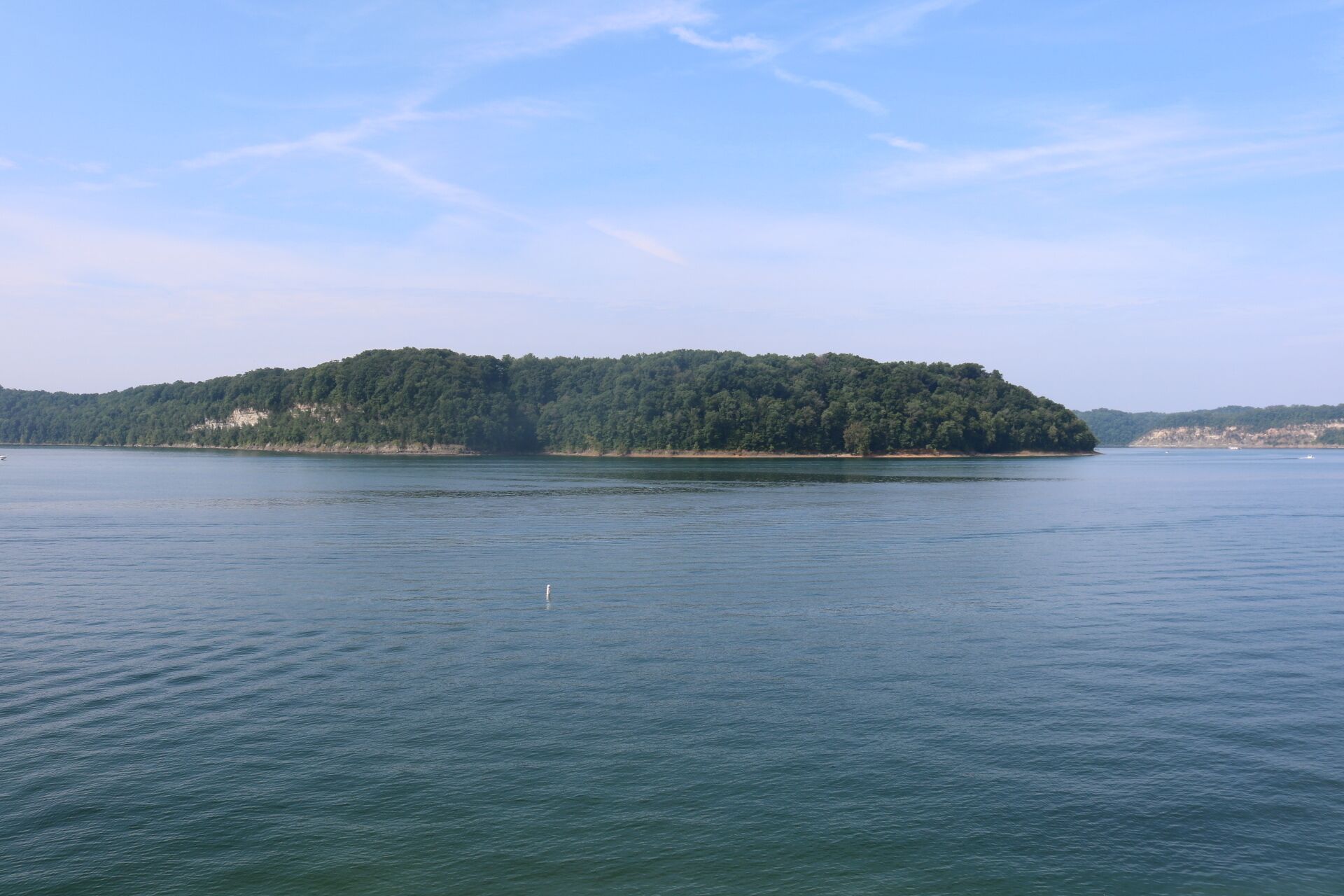 Une grande île couverte de forêts, entourée d’eaux calmes.