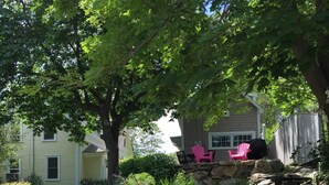 A backyard with a stone staircase, large rocks, and a garden.