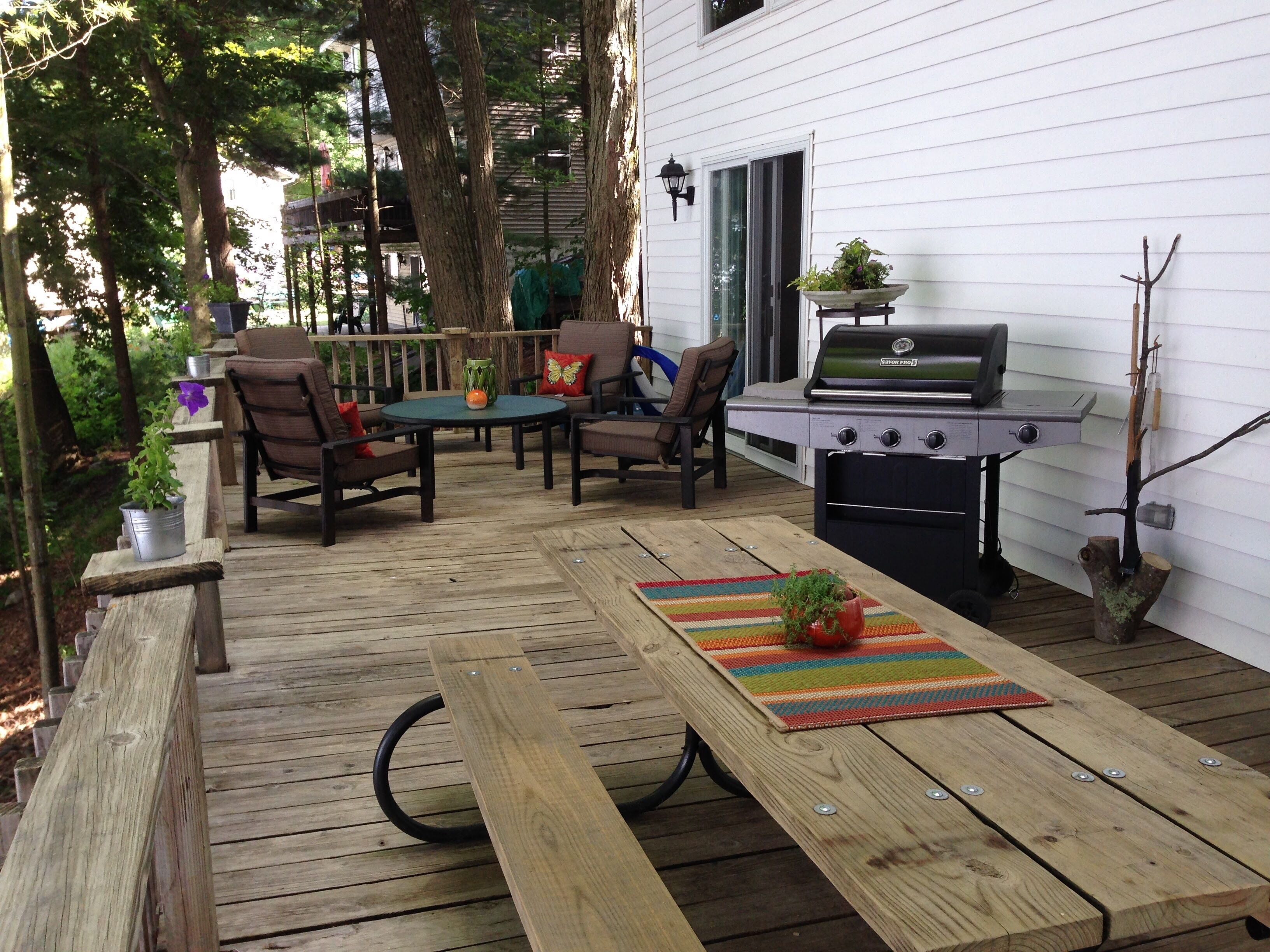 Outside living  and dining area with gas grill.