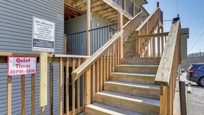 A wooden staircase leading to a building with signs indicating no smoking and quiet time rules. - 2 Mi to Silver Dollar City: Condo in Branson West (Reeds Spring)