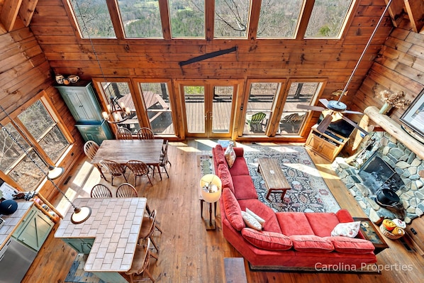 You can see the living and dining areas from the loft. You can also see the wall of windows.