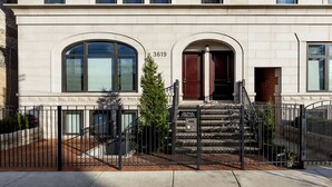 A building with a stone facade, numbered 3619, featuring a gated entrance with a staircase leading to the main entrance. - Wrigley Field All Star Suite 3 Bedrooms 2 Bath (Chicago)