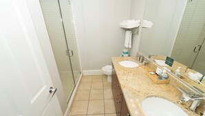 A bathroom with two sinks, a shower, and a toilet. - Wrigley Field All Star Suite 3 Bedrooms 2 Bath (Chicago)