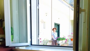 A room with a large window, a wooden table with a white cloth, and a chair. - Rome: Delightful tiny apartment close to the Colosseum (Roma)