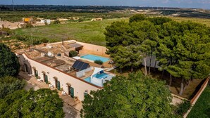 An aerial view of a property with a swimming pool, solar panels, and a large tree. - Casale Domè 14+2, Emma Villas (Ciavolo)