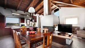 A spacious living area with a dining table, chairs, a fireplace, and a television. - Le Orchidee Luxury Country Villa with pool just minutes from the Riviera (Roncofreddo)