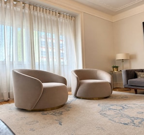 A room with two armchairs, a sofa, a lamp, and a large window with curtains. - Boutique Stunning Apartment - Liberdade Avenue (Lisboa)