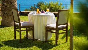 A table set outdoors with a view of a body of water and hills in the background. - Villa Imperia 3 bedroom luxury villa - 200m from the beach (Elounda)