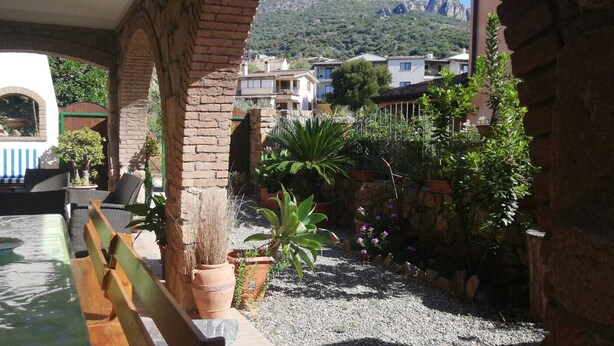 A courtyard with a pool, outdoor seating, and potted plants. - HOUSE WITH VERANDA AT A FEW STEPS FROM THE SEA (Santa Maria Navarrese)