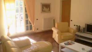A living room with a sofa, armchair, and a small table.