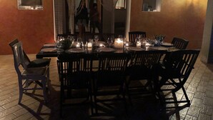 A dining area with a long table set for multiple people, surrounded by chairs. - Villa set in the beautiful countryside, 5 mins to fantastic beaches & Islands (Arzachena)