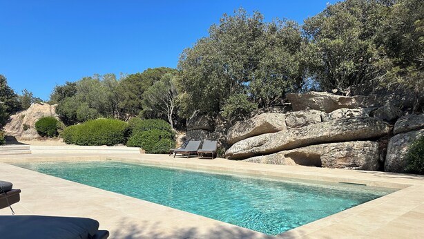 A rectangular pool with clear blue water, surrounded by a stone deck. There are lounge chairs along the poolside. - Villa set in the beautiful countryside, 5 mins to fantastic beaches & Islands (Arzachena)