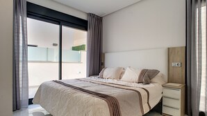 A modern bedroom with a large bed, a nightstand, and a view of the outdoors. - Private pool villa, free wifi, hot tub, roof terrace (Roda)