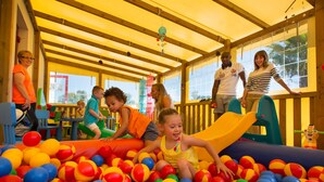A play area with a slide and a ball pit filled with multicolored balls. - **** SPACIOUS MOBILE HOME 1/8 PERS LES CHARMETTES **** (Les Mathes)