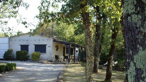 A rustic building with a gravel driveway, a covered outdoor seating area, and a tree-lined path. - Pretty detached house. not overlooked, swimming pool. near Sarlat/Rocamadour (lachapelle haute)